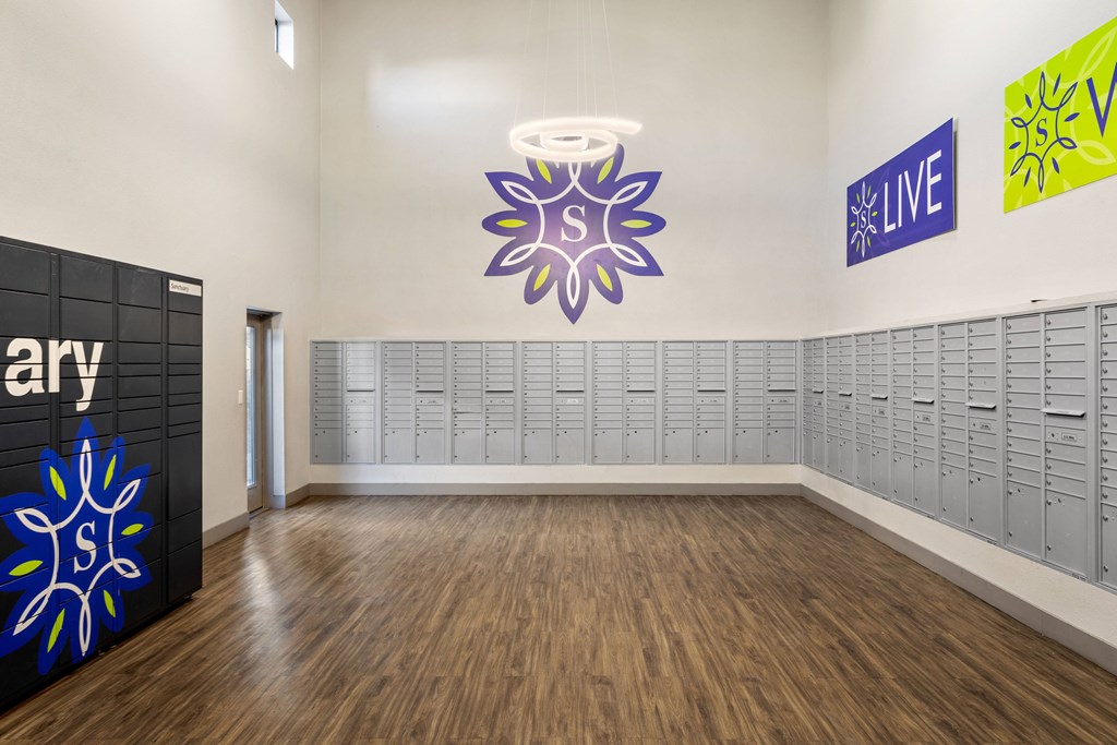 a large room with lockers and a large painting on the wall